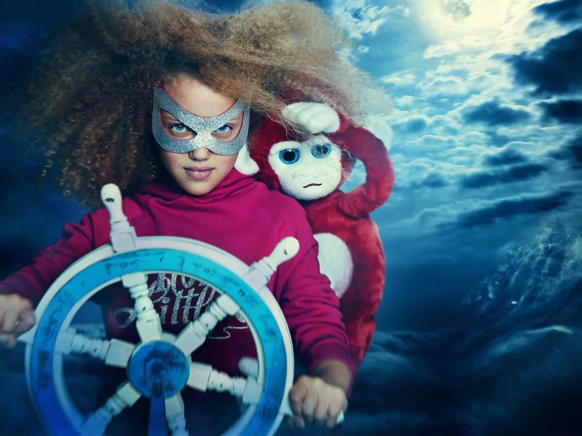 Ilvie Little dressed as a fearless pirate, steering a ship through a dramatic ocean adventure.